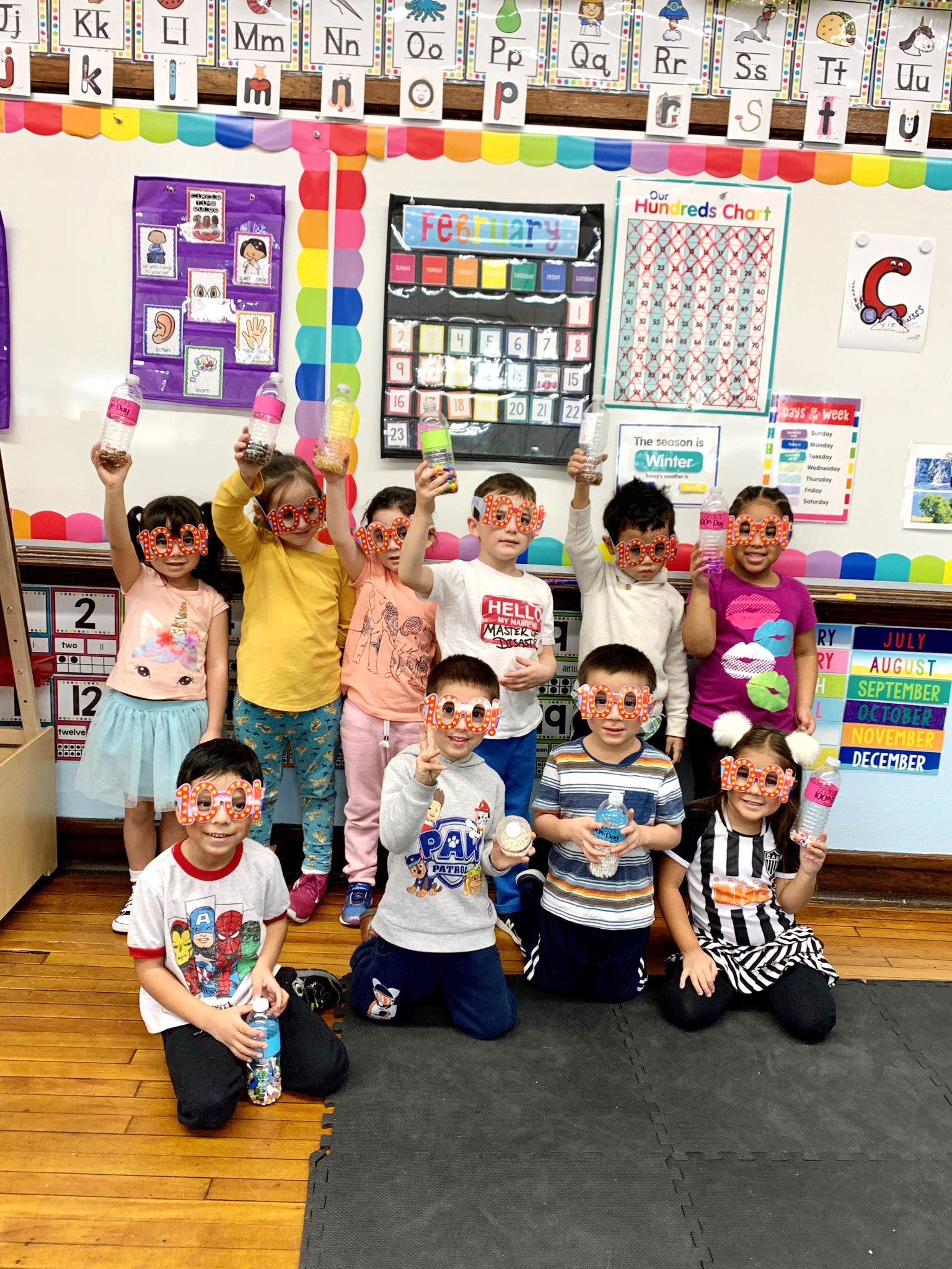 Pre-K students gather for a group photo inside a classroom