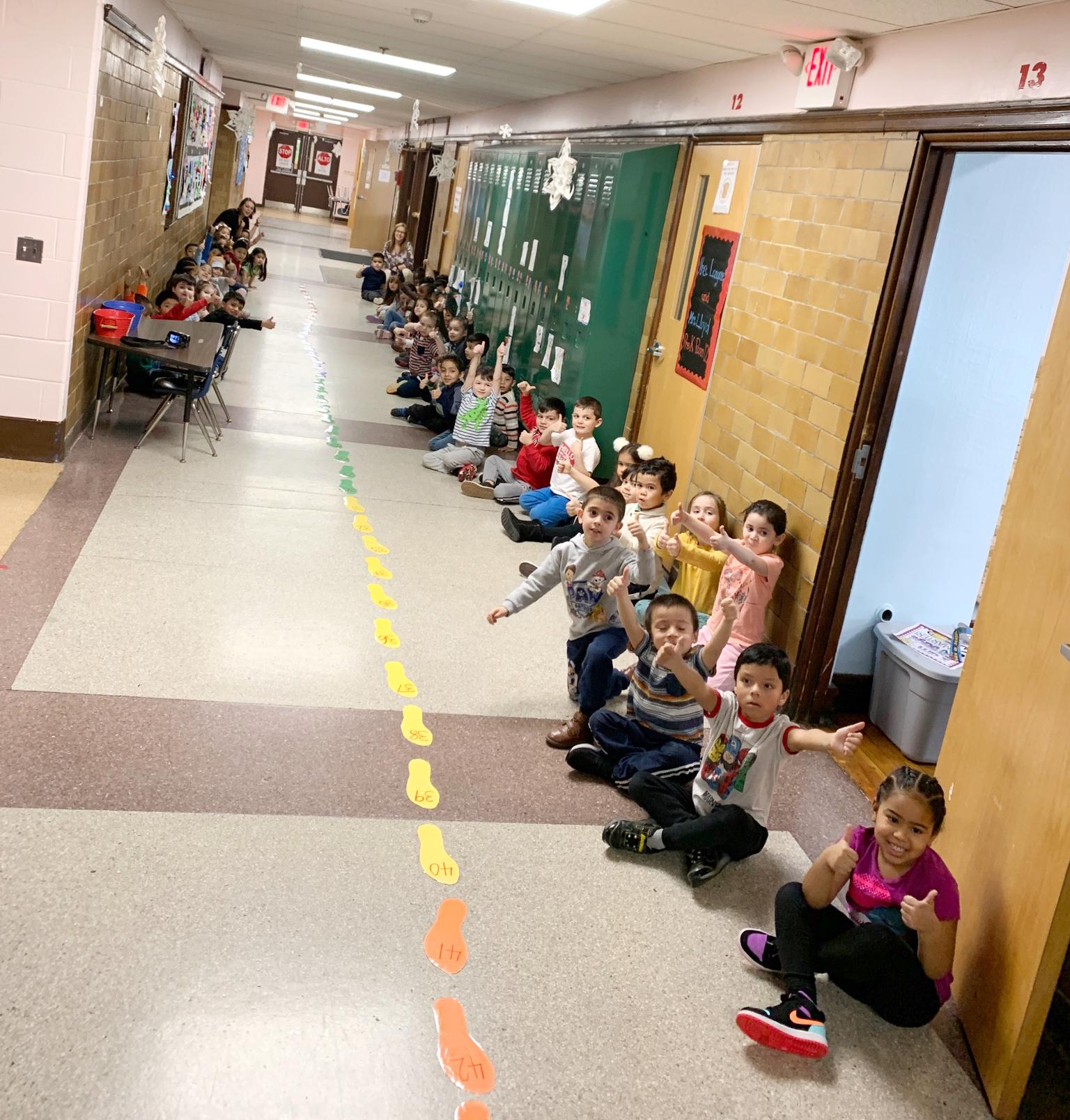 Pre-K students gather in a hallway